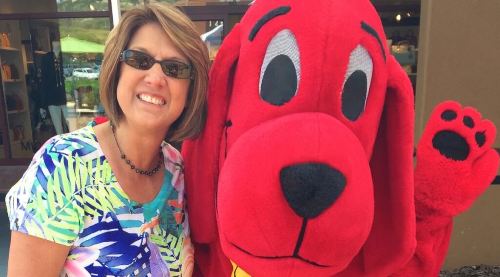 Snappy Face Painting Owner with Big Red Dog at Event