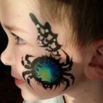 Green and Blue Tarantula Spider cheek art by Snappy Face Painting