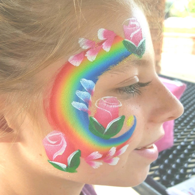 Neon Rainbow and Roses cheek art by Snappy Face Painting