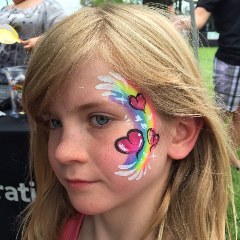 Simple Rainbow and Hearts cheek art design by Snappy Face Painting