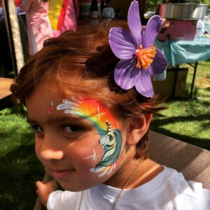 Neon Rainbow and Unicorn cheek art by Snappy Face Painting